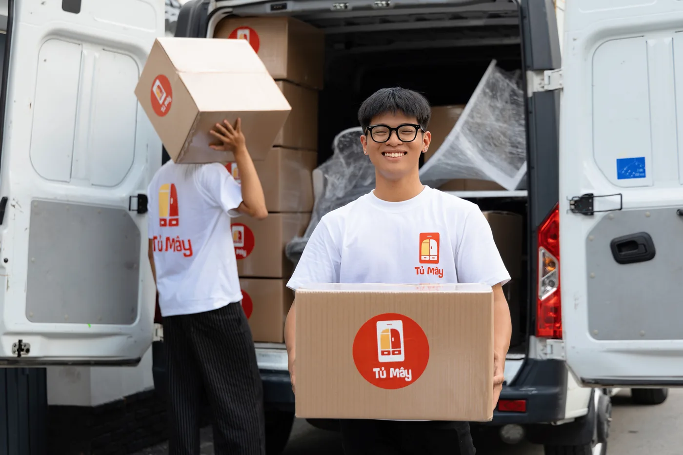 Crew member carrying a box on his shoulder