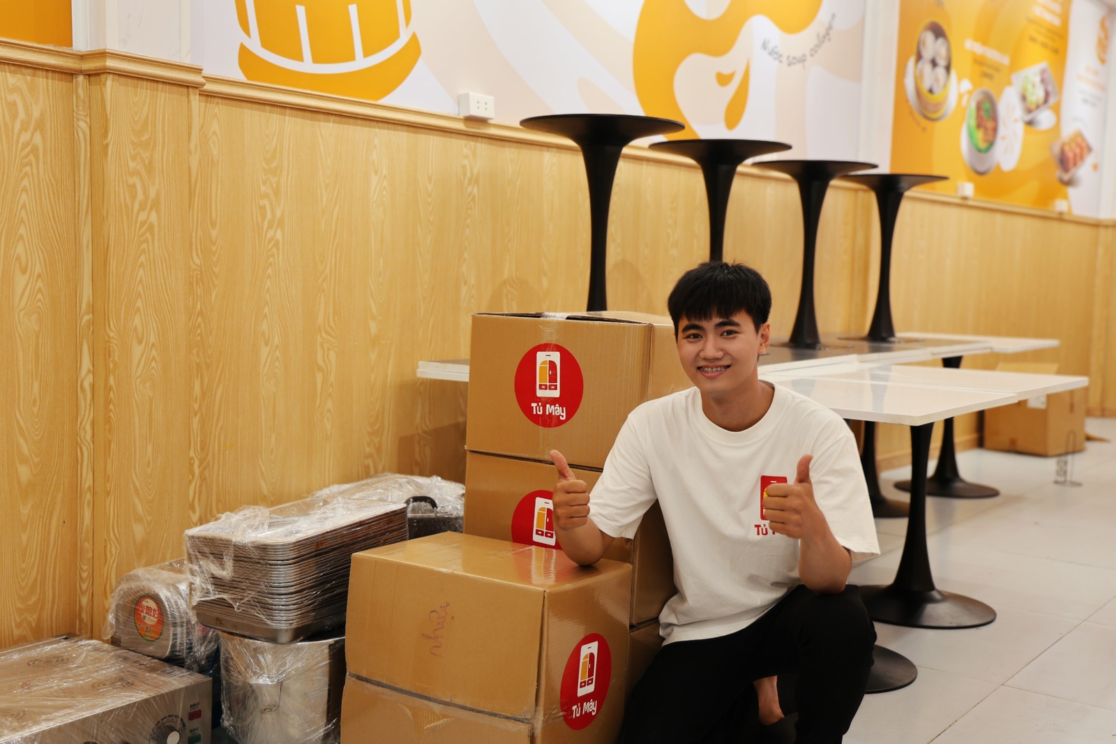 Sealed Tủ Mây boxes beside dismantled table tops and pedestals